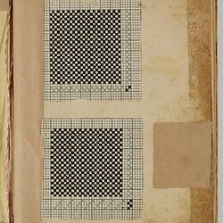 White sheet with two black square gridded weaving patterns.
