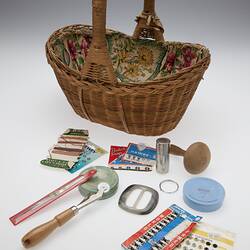 Cane basket pictured with sewing accessories.