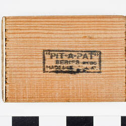 Underside of wooden tray stamped Pit-a-Pat