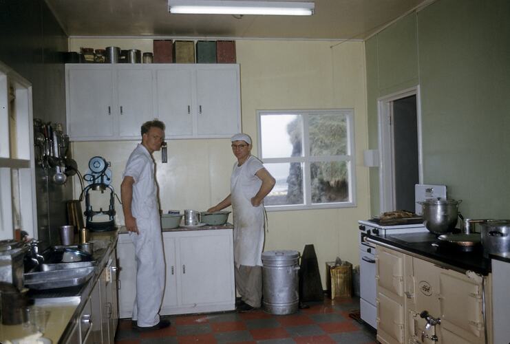 Two men in kitchen.