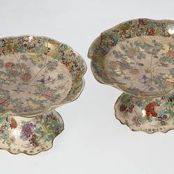 Pair of cream coloured compote with wavy edges decorated with birds & chrysanthemums.