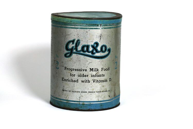 Cylindrical metal tin, blue and silver, with name 'Glaxo'