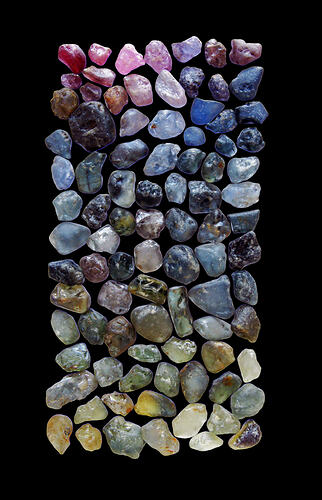 Large number of uncut sapphires of various colours.