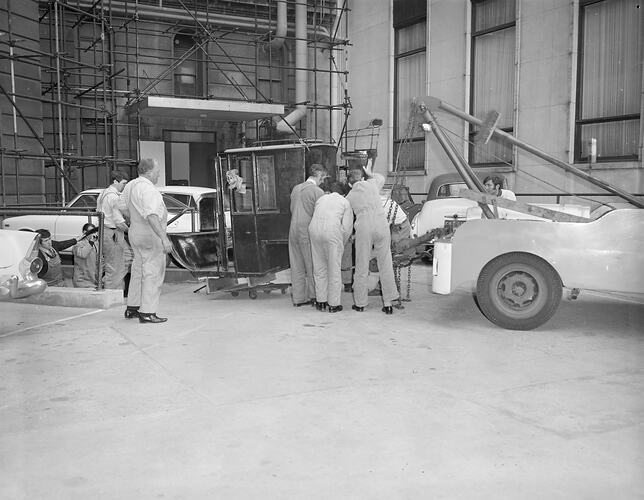 Staff moving Hansom cab up from State Library basement 2 August 1972