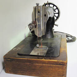 End view of electric sewing machine.
