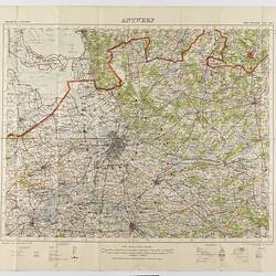 Map, paper backed with cloth, printed in black, green, blue and red on white. Treed areas in green.