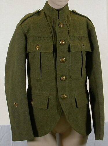 Khaki tunic with two hip pockets with button flaps. Two breast pockets with pleat and button flaps.