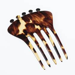 Tortoiseshell hair comb, five tines and knobs on base.