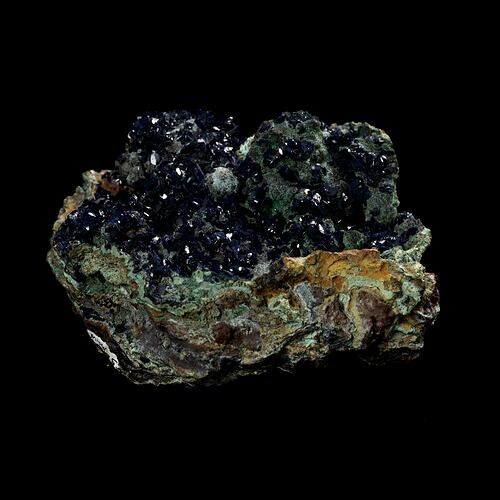 Blue crystals on green-stained rock.