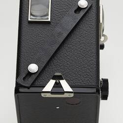 Small black box camera showing handle strap.