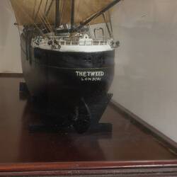 Sailing ship model in glass case, rear view.