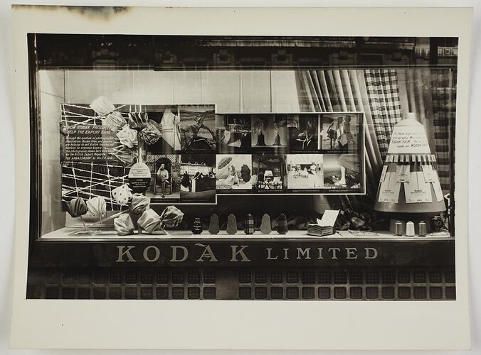Kodak shopfront display of photographs with fabrics and signage.