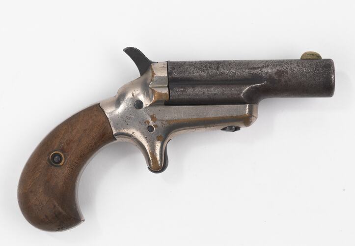 Pistol, metal with wooden grip.