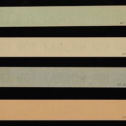 Back of four paper strips in green, yellow, blue and orange.