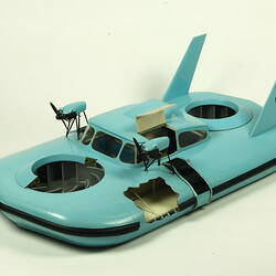 Light blue hovercraft with two propellers, three quarter view.