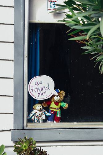 Teddies with sign placed in window.