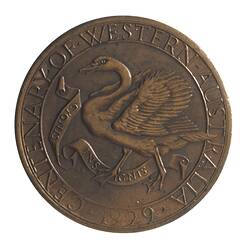 Round bronze-coloured medal with swan advancing left with wings spread, text around edge.