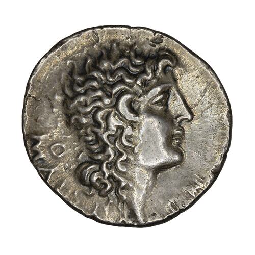 Head of Alexander the Great with horn of Ammon and flowing long hair, facing right.