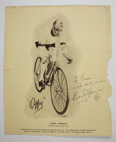 Signed image of Hubert Opperman on bicycle.