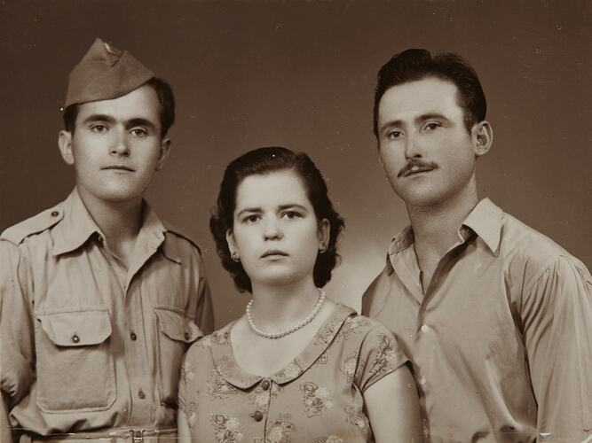 Portrait of man in uniform, woman and man.