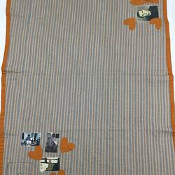 Quilt made from striped shirts. Two corners have fabric photos of a man and boy, hearts and pocket.