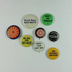 Eight round colourful badges of varying size.