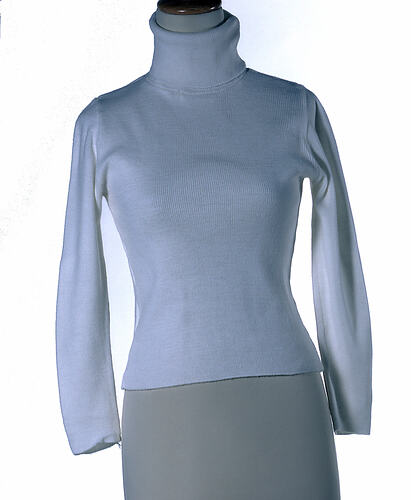 White knitted acrylic long-sleeved polo-necked jumper.