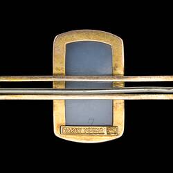 Back of gold bar brooch with centrally placed, rectangular cameo in gold setting. Horizontal pin.