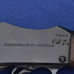 Detail of maker's name on rifle.