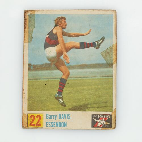 Football card, number 22, with player kicking ball, leg up and extended.