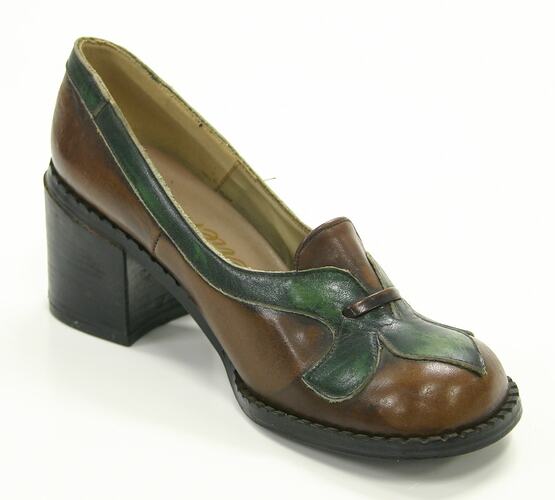 Brown and green leather shoe with heel.