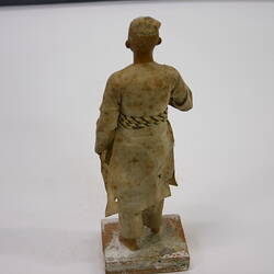 Pottery figure of a man  with a distinctive belt.