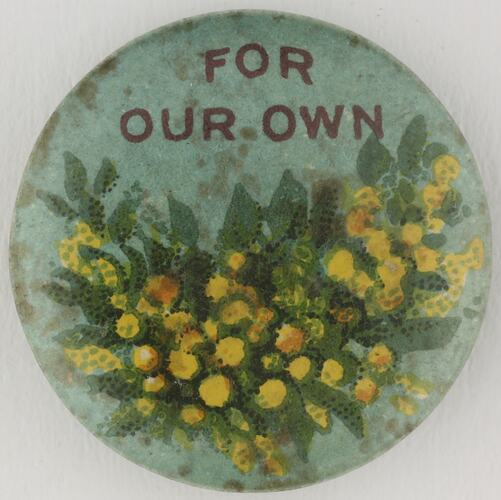 Round badge with yellow wattle image.