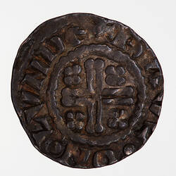 Coin, round, short cross voided within a beaded circle, a quatrefoil in each angle; text around, RAVL ON LVND.