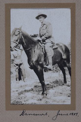 Man in military uniform on horseback with written text below.