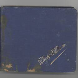Cover of cloth-covered photograph album with gilt title.