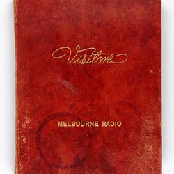 Red "Visitors" book for Melbourne radio with coffee rings