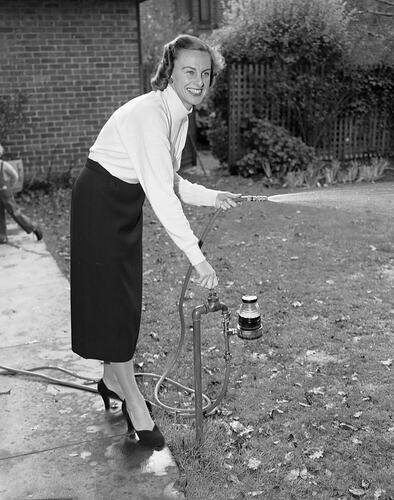 Woman Using a Garden Hose, Victoria, May 1954