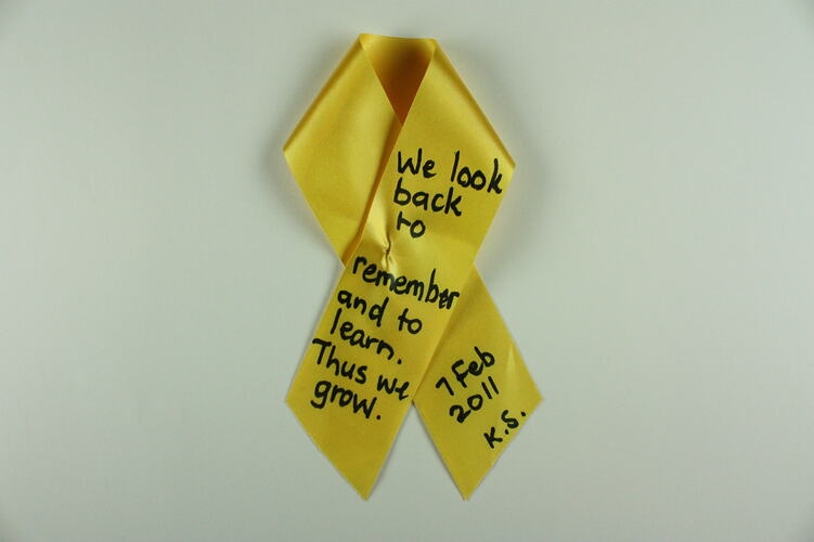 Yellow ribbon with handwriting.