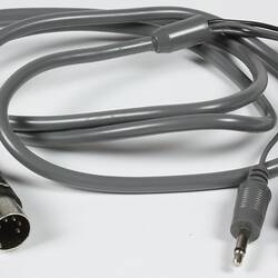 Silver electrical lead with three inputs, one output.
