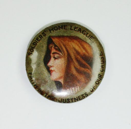 Badge with hooded female head.