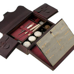 Sewing kit in leather box, lined with red velvet.