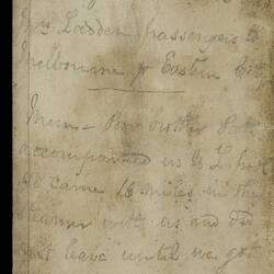 Open diary with handwritten text on discoloured worn page.