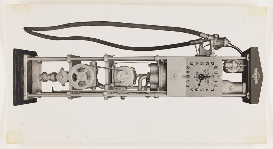 Monochrome photograph of an electric petrol pump.