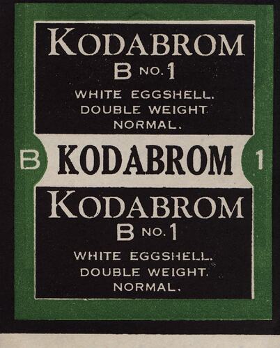 Black and white paper label with green border.