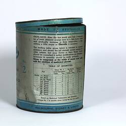 Cylindrical metal tin, blue and silver, with black text