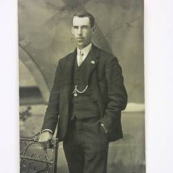 Three-quarter portrait of man in suit and tie.