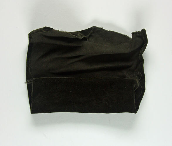 Rolled piece of brown velvet.