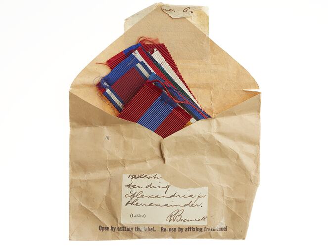 Brown paper envelope containing military medal ribbons.