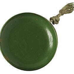 Green side of blue/green wooden yo-yo with string.